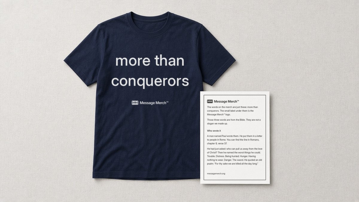 Navy shirt printed with more than conquerors and a small Message Merch logo, beside the Message Merch card that explains the words