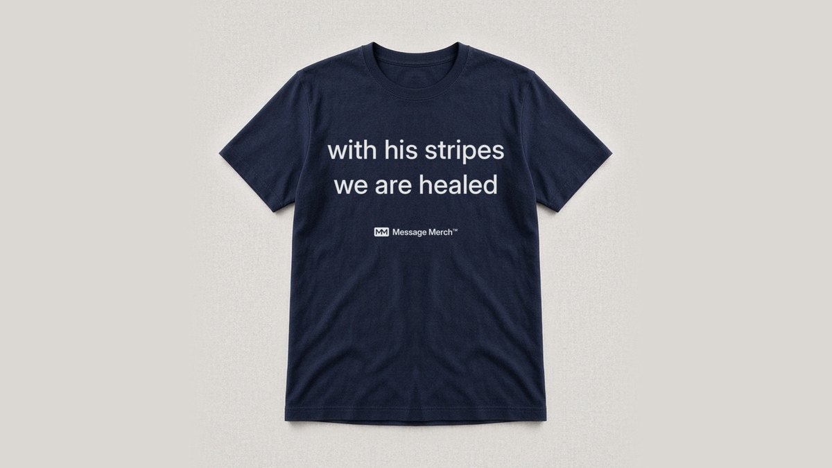 Navy shirt printed with with his stripes we are healed, with a small Message Merch logo under the words